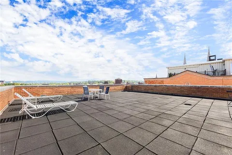 a terrace with outdoor seating and city view