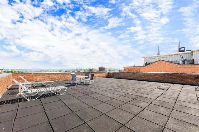 a terrace with outdoor seating and city view
