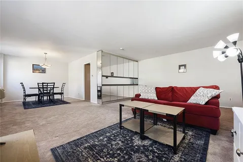 a living room with furniture and kitchen view