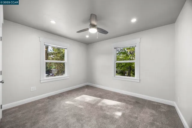 an empty room with windows and closet