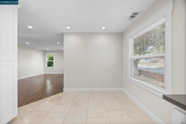 a large kitchen with stainless steel appliances granite countertop a stove a sink and a refrigerator