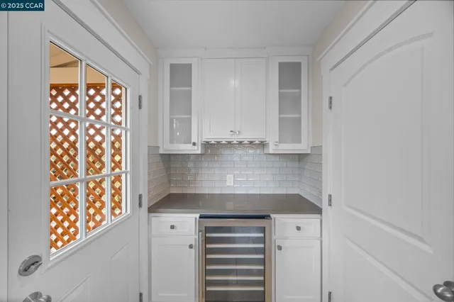 a kitchen with cabinets and a refrigerator