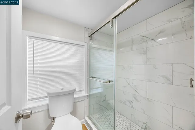 a view of a kitchen with a sink and a refrigerator