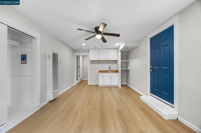 a view of empty room with wooden floor