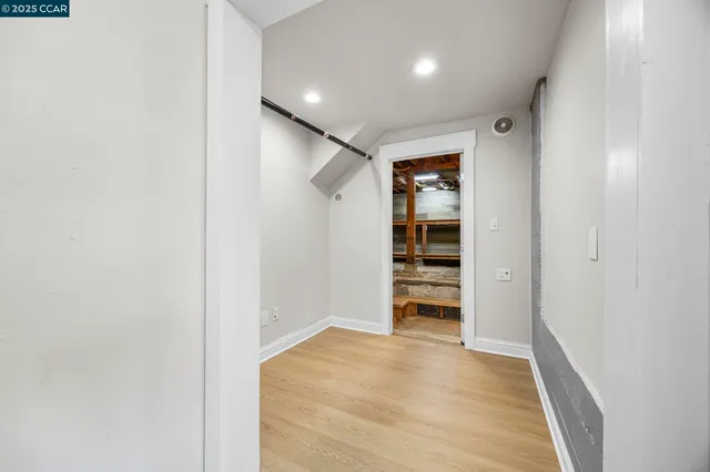 a view of a house with wooden fence and large trees