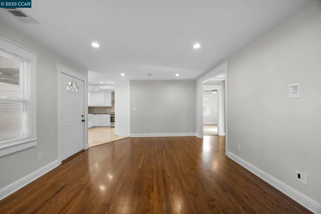a view of a kitchen with wooden floor and a kitchen