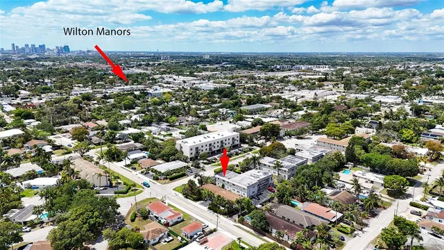 an aerial view of multiple houses with a yard