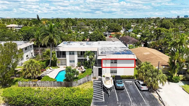 a aerial view of a house with swimming pool and sitting area