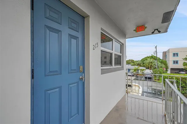 a view of house with swimming pool and deck