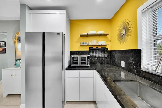 a kitchen with stainless steel appliances a sink and a microwave