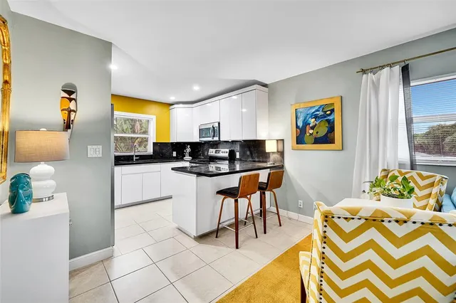 a kitchen with stainless steel appliances kitchen island granite countertop a sink and cabinets