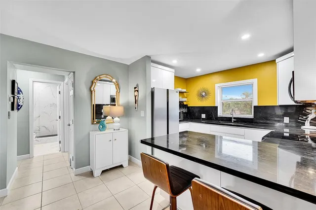 a kitchen with stainless steel appliances granite countertop a sink and cabinets
