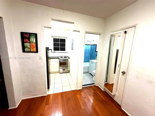 a view of a kitchen from a hallway