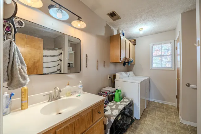 a bathroom with a sink mirror and a toilet