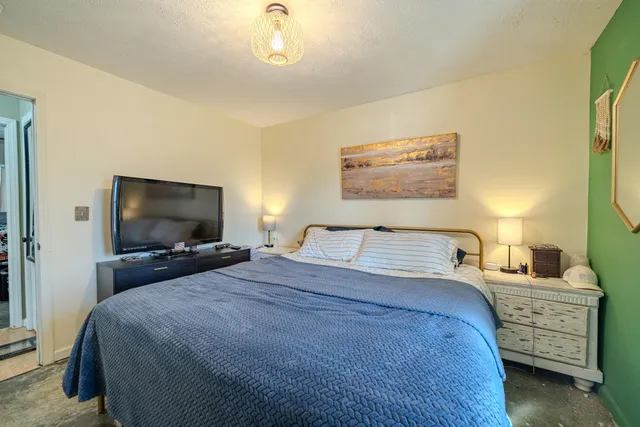 a bedroom with a bed and a flat screen tv