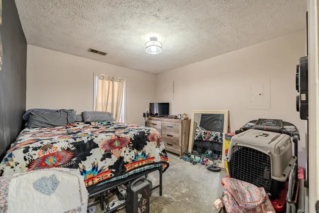 a bedroom with bed and a window