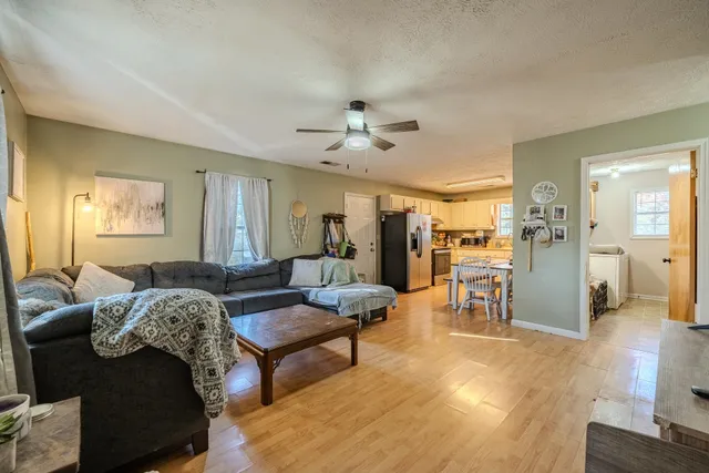 a living room with furniture and a chandelier