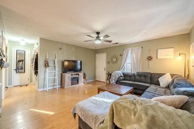 a living room with furniture and a flat screen tv