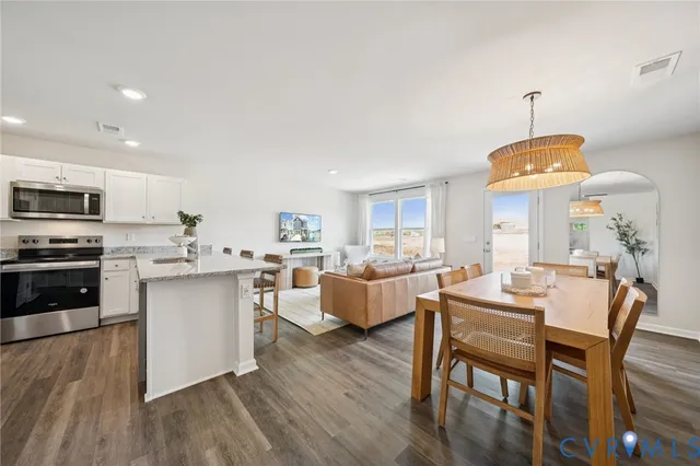 a kitchen with counter space dining table and chairs