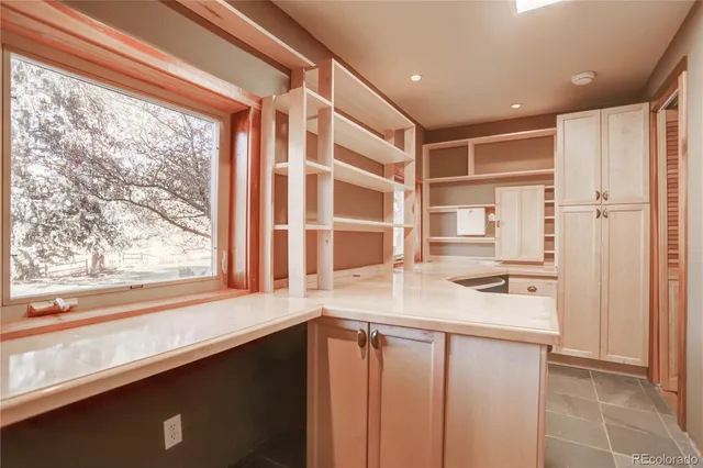 a kitchen with a window wooden floor and a sink