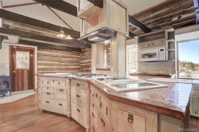 a kitchen with stainless steel appliances granite countertop a sink a stove and cabinets