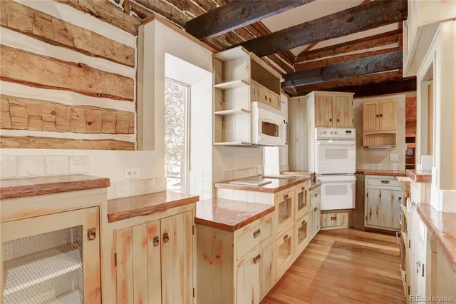 a kitchen with stainless steel appliances granite countertop a stove and a refrigerator