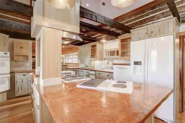 a kitchen with stainless steel appliances a stove a refrigerator and cabinets