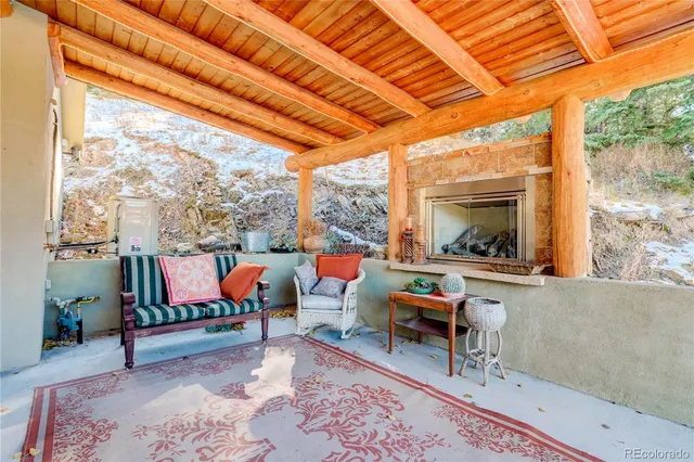a living room with patio furniture and a large window