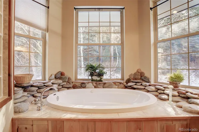 a bathroom with sink and large window