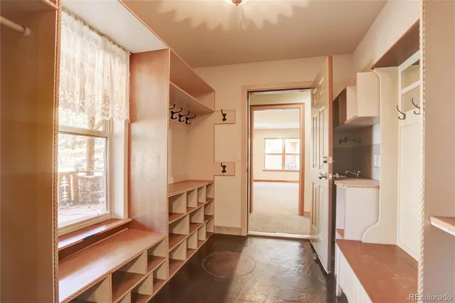 a view of a room with wooden floor and windows
