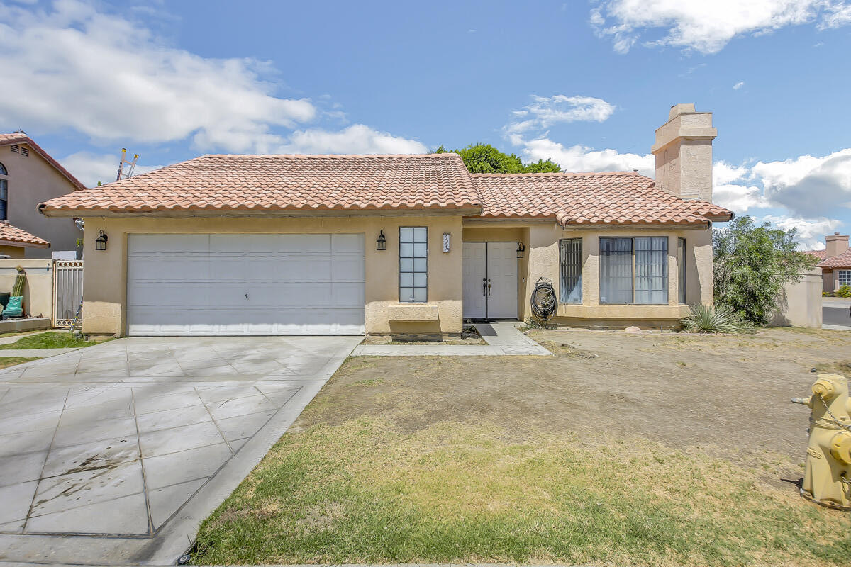 45535 Indian River Road Indio, CA 92201 - Photo 1 of 29 a front view of a house with a yard and garage