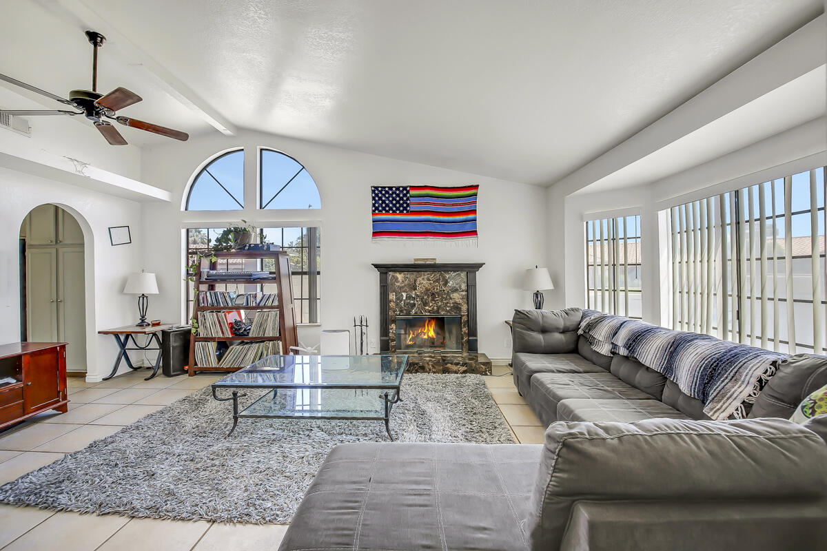 45535 Indian River Road Indio, CA 92201 - Photo 7 of 29 a living room with furniture a fireplace and a large window