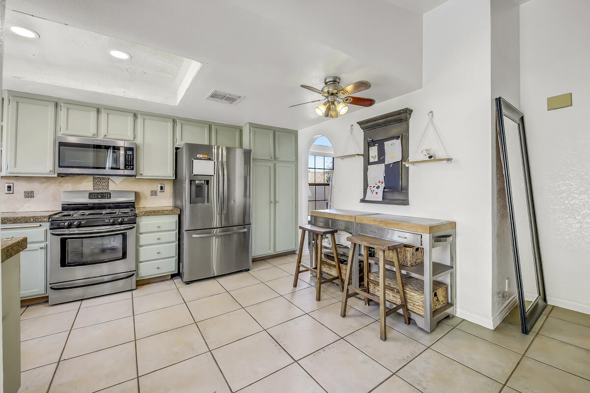45535 Indian River Road Indio, CA 92201 - Photo 10 of 29 a kitchen with stainless steel appliances a refrigerator and a stove top oven