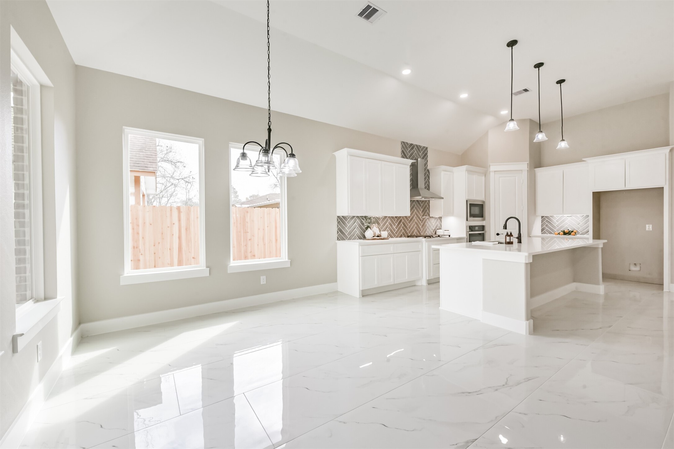 2803 Lancaster Lane Pasadena, TX 77506 - Photo 15 of 45 a large kitchen with white cabinets and stainless steel appliances