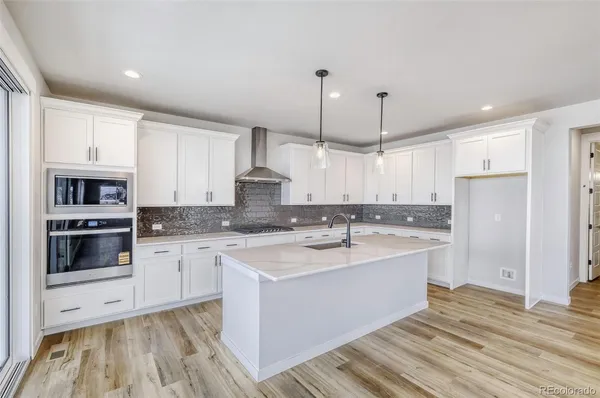 a kitchen with a sink stove and refrigerator