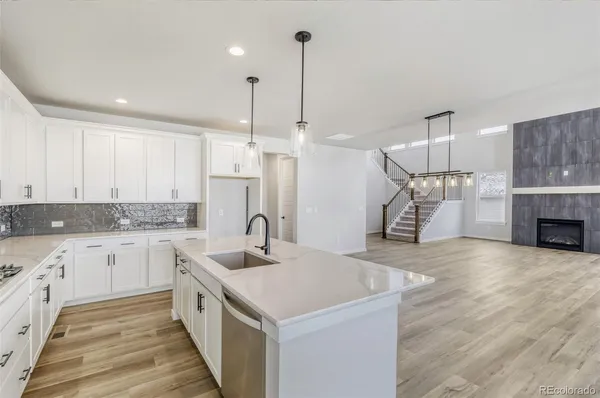 a kitchen with a sink cabinets and wooden floor