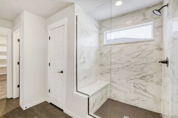 a bathroom with a shower and a glass door