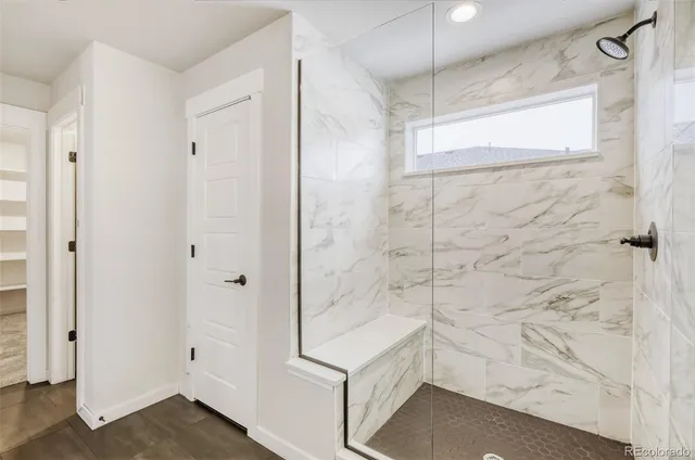 a bathroom with a shower and a glass door