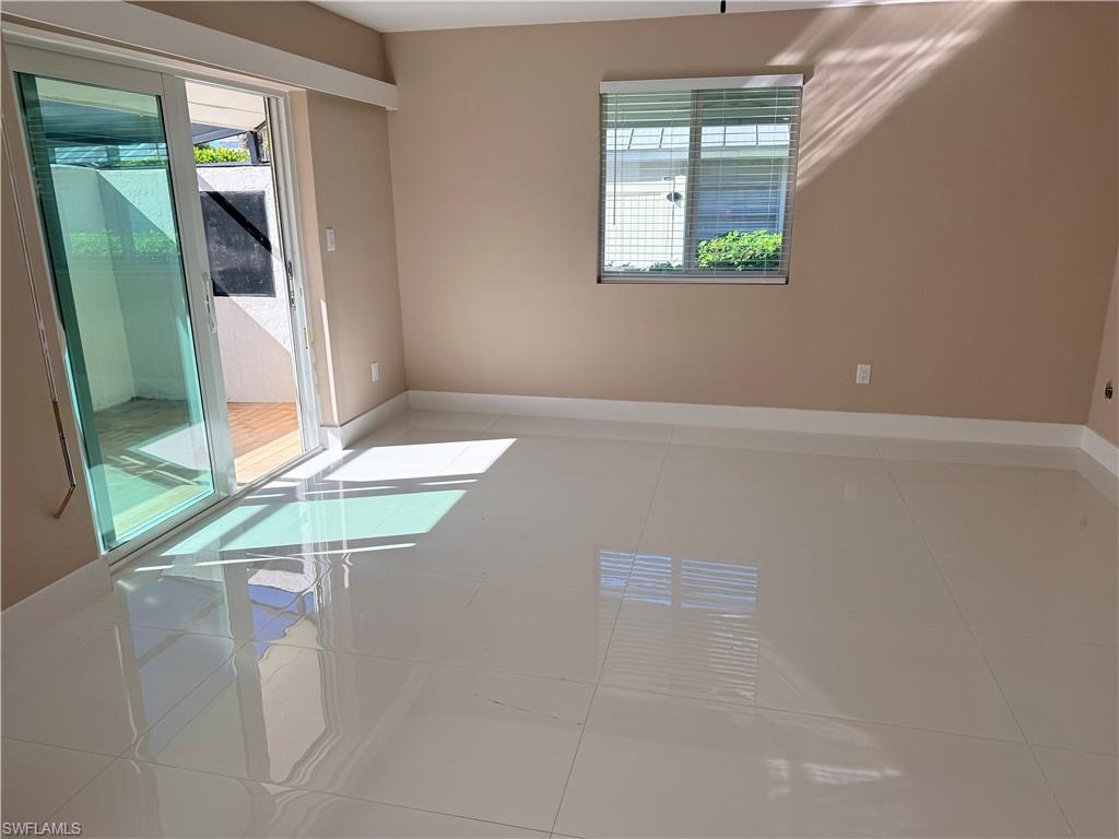 1575 Curlew Avenue, Unit 1 Naples, FL 34102 - Photo 15 of 35 Great room plenty of natural light, and large light tile floors leading out to your private lanai.