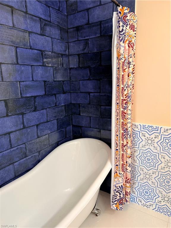 1575 Curlew Avenue, Unit 1 Naples, FL 34102 - Photo 30 of 35 Bathroom with a soaking tub and curtained shower