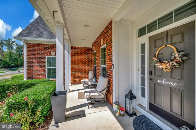 a view of a hallway with wooden floor and workspace