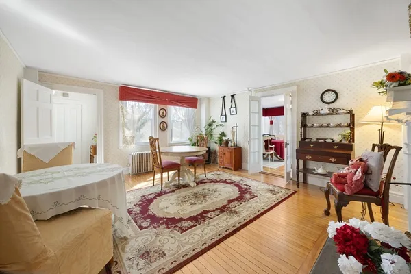 a living room with furniture and wooden floor