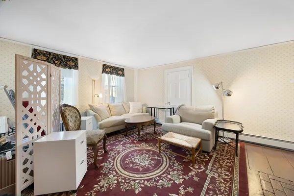 a living room with furniture a rug and a window