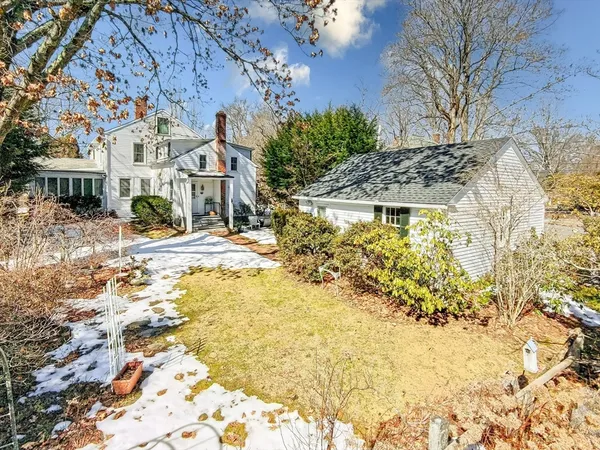 a front view of a house with a yard covered with snow