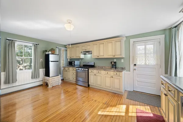 a kitchen with sink refrigerator and window