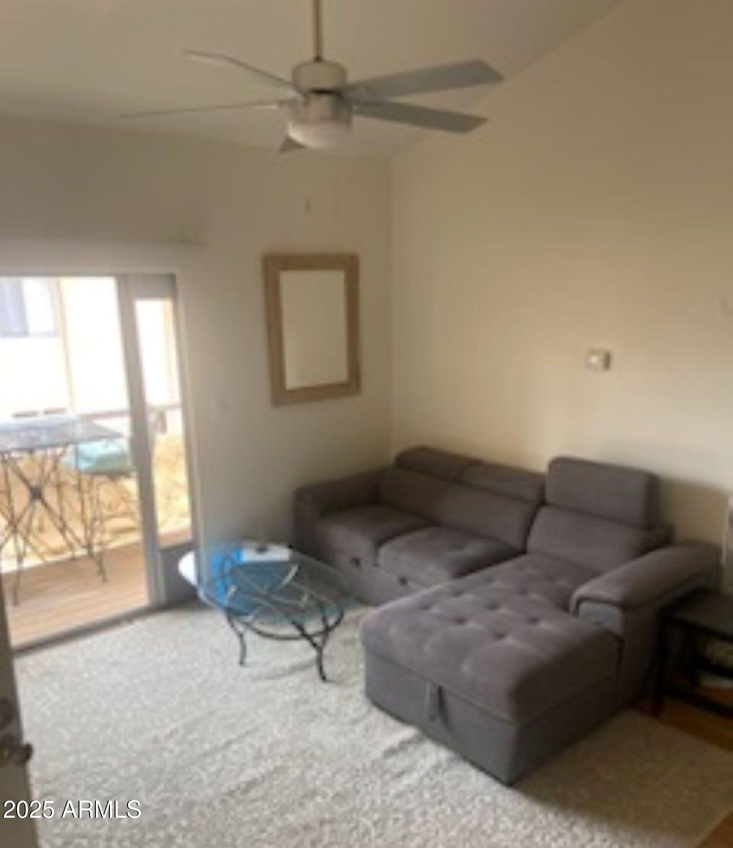 8055 East Thomas Road, Unit A303 Scottsdale, AZ 85251 - Photo 16 of 25 a living room with furniture and a floor to ceiling window