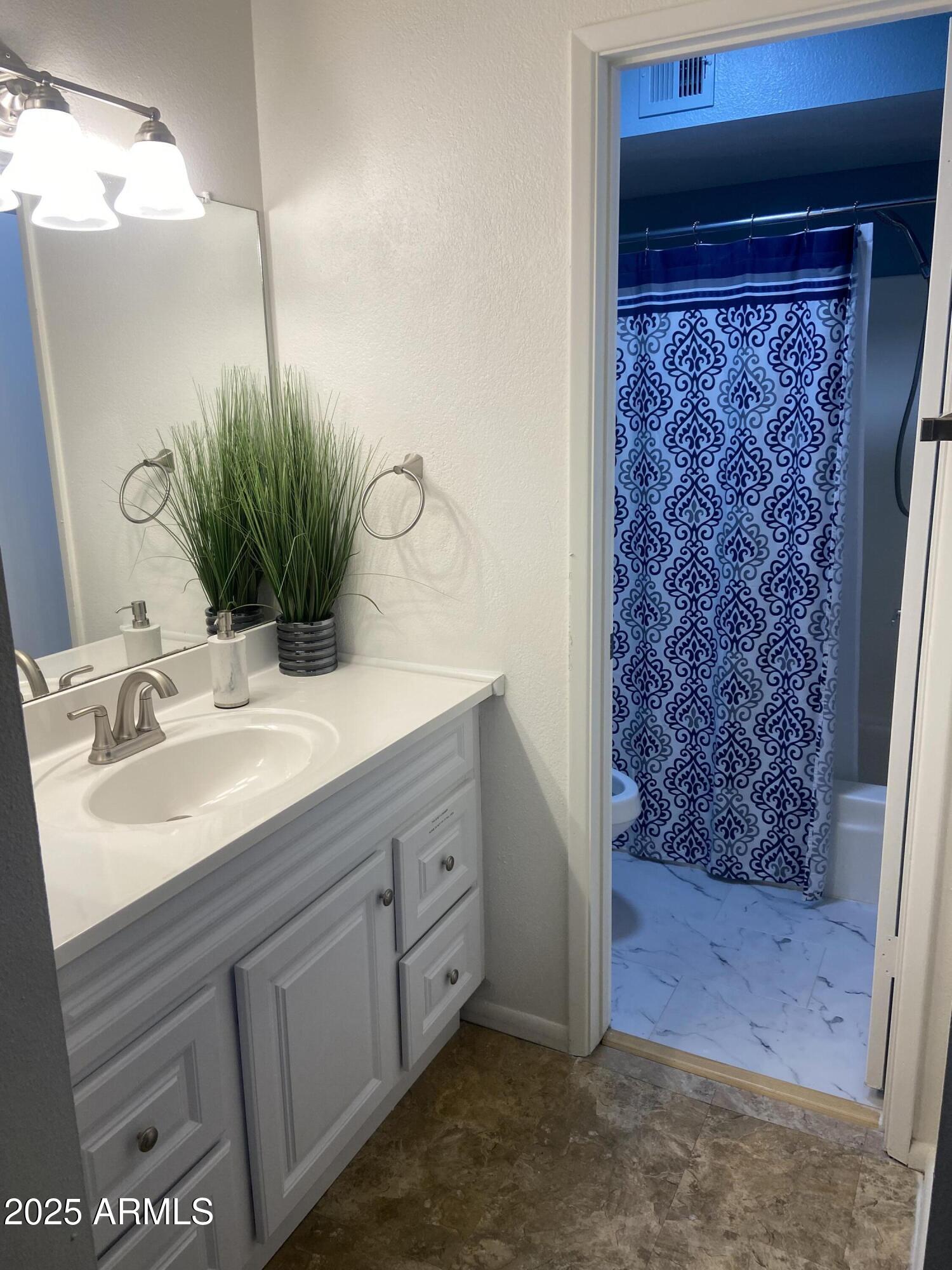 8055 East Thomas Road, Unit A303 Scottsdale, AZ 85251 - Photo 17 of 25 a bathroom with a sink and a mirror
