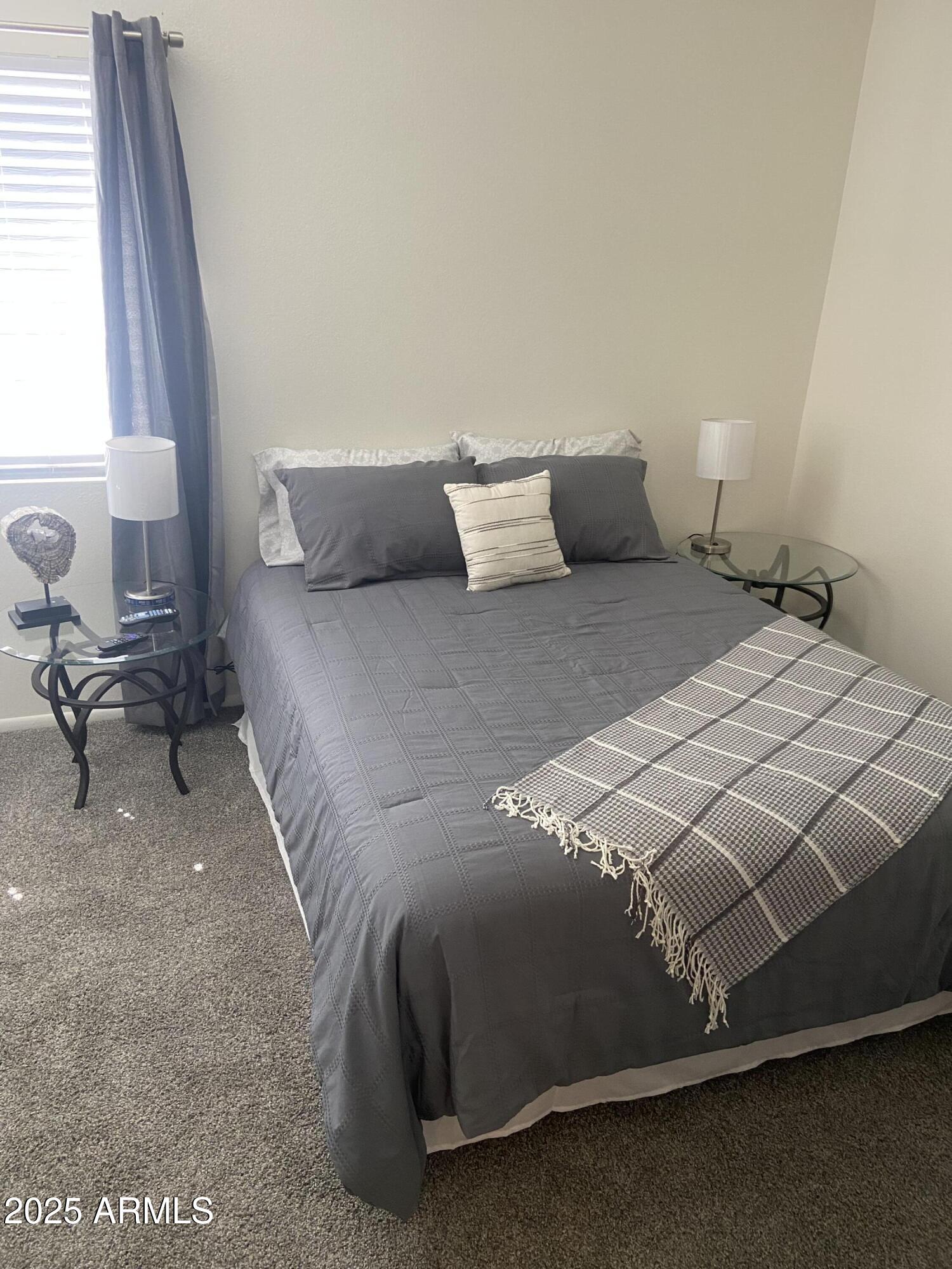 8055 East Thomas Road, Unit A303 Scottsdale, AZ 85251 - Photo 2 of 25 a bedroom with a bed and chair