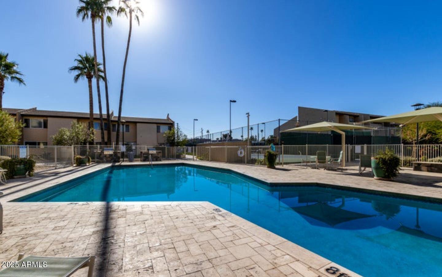 8055 East Thomas Road, Unit A303 Scottsdale, AZ 85251 - Photo 21 of 25 a view of a kitchen with swimming pool and sitting area