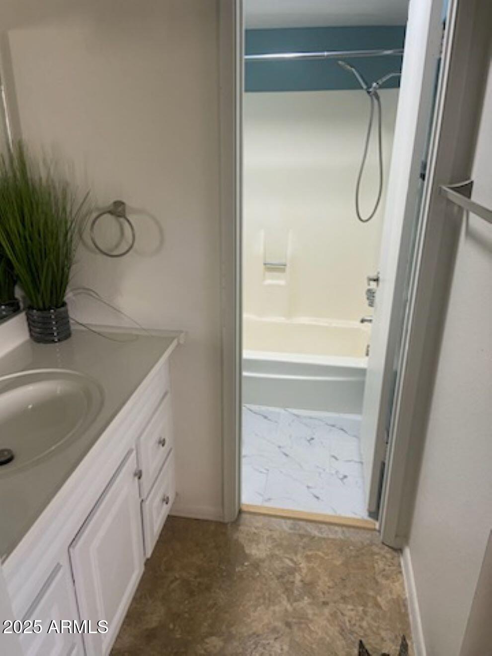 8055 East Thomas Road, Unit A303 Scottsdale, AZ 85251 - Photo 5 of 25 a bathroom with a granite countertop sink a mirror and a bathtub